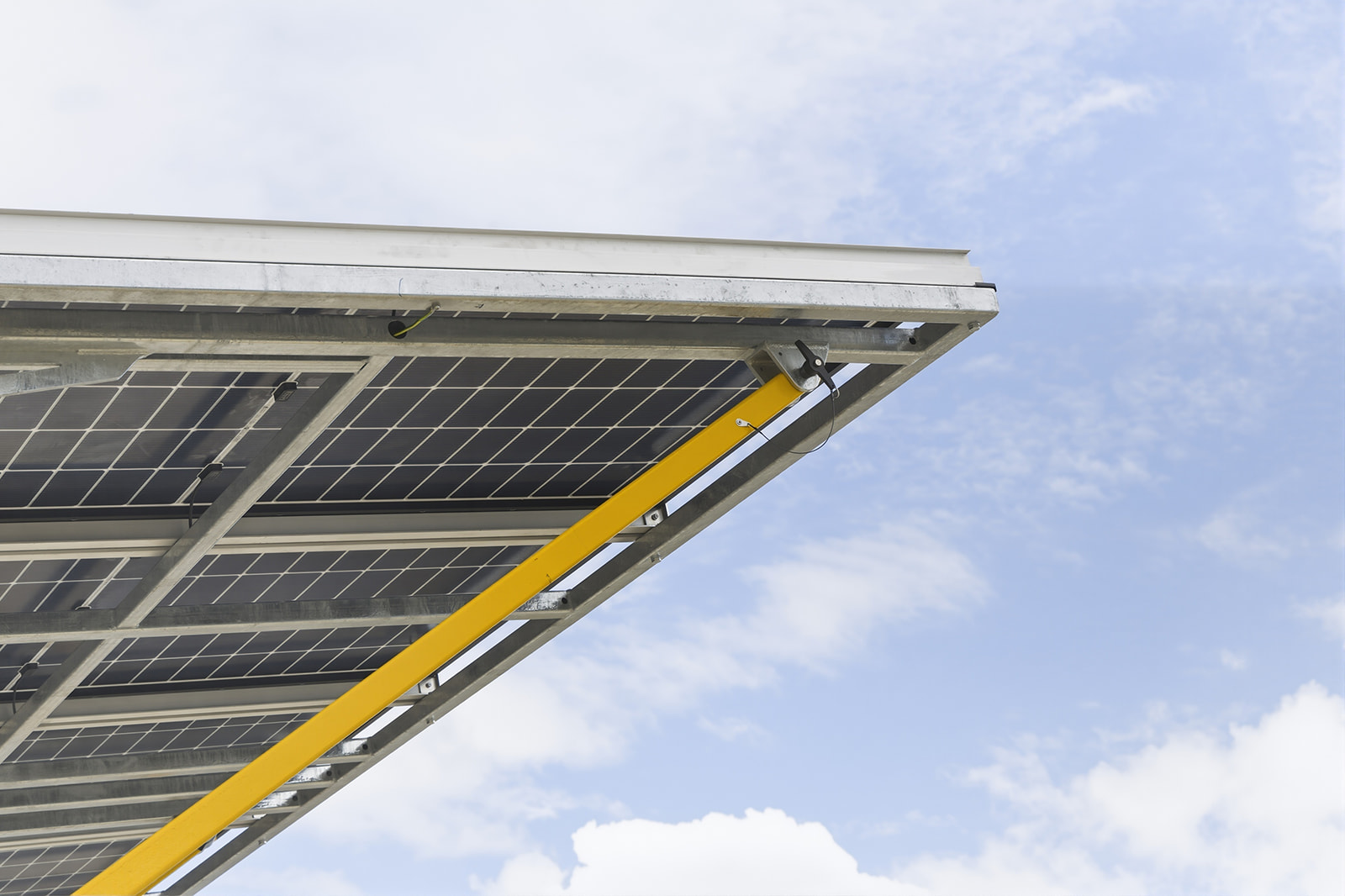 Wide angle view underneath the solar panel array of a CSE Linked Solar Trailer against the sky, Mackay