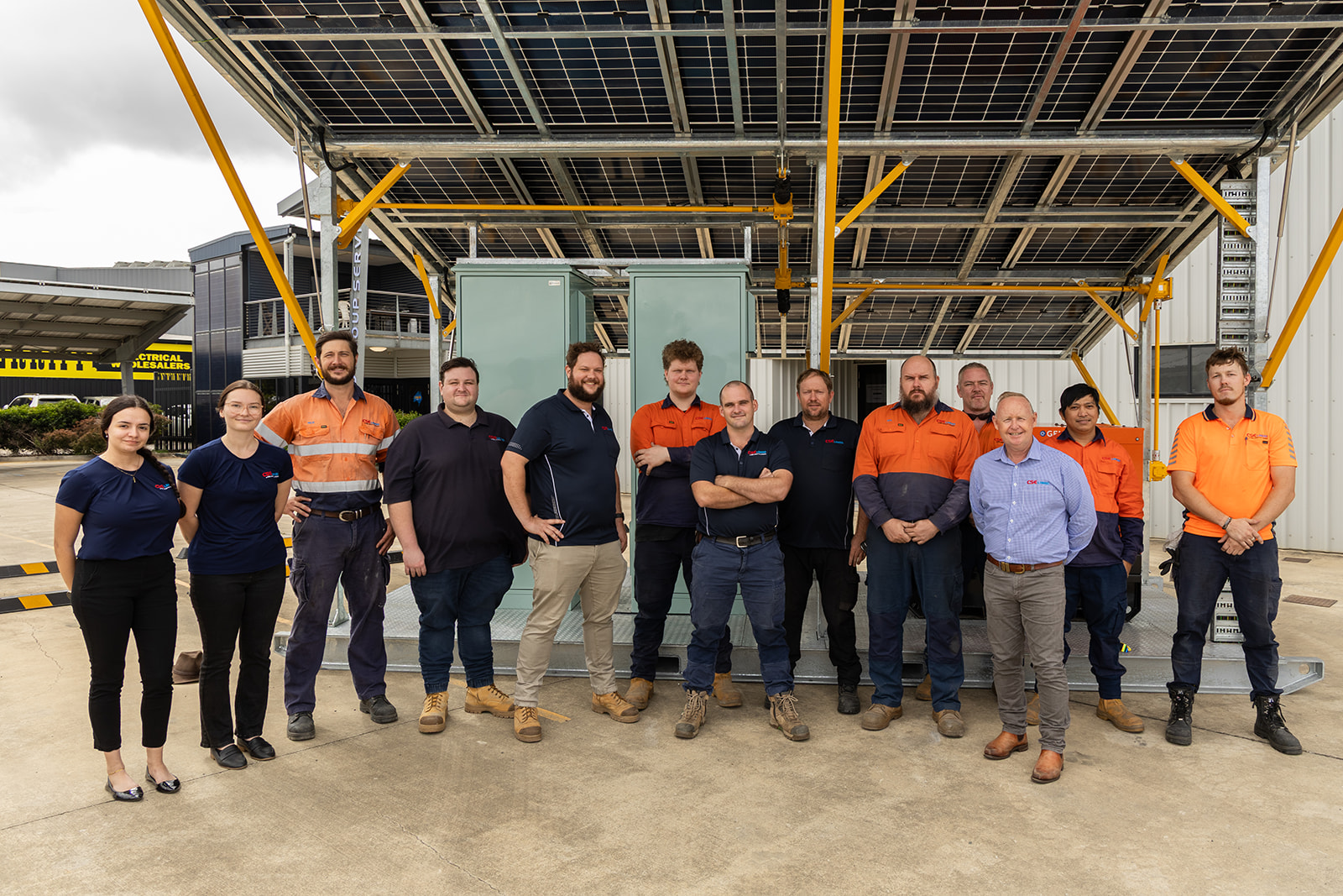 CSE Linked team group photo in front of a Solar Trailer at their Mackay yard