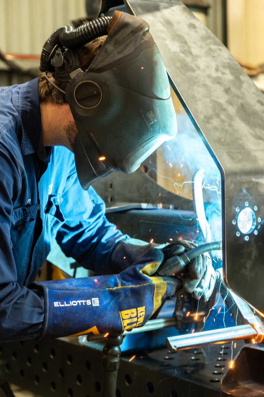 Welder fabricating a steel component in the EHS Manufacturing workshop, Mackay