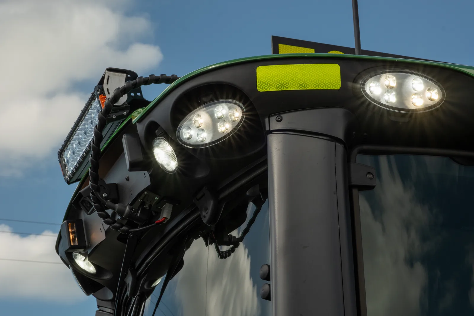LED work lights on a John Deere tractor cab fitted out by EHS Manufacturing, Mackay