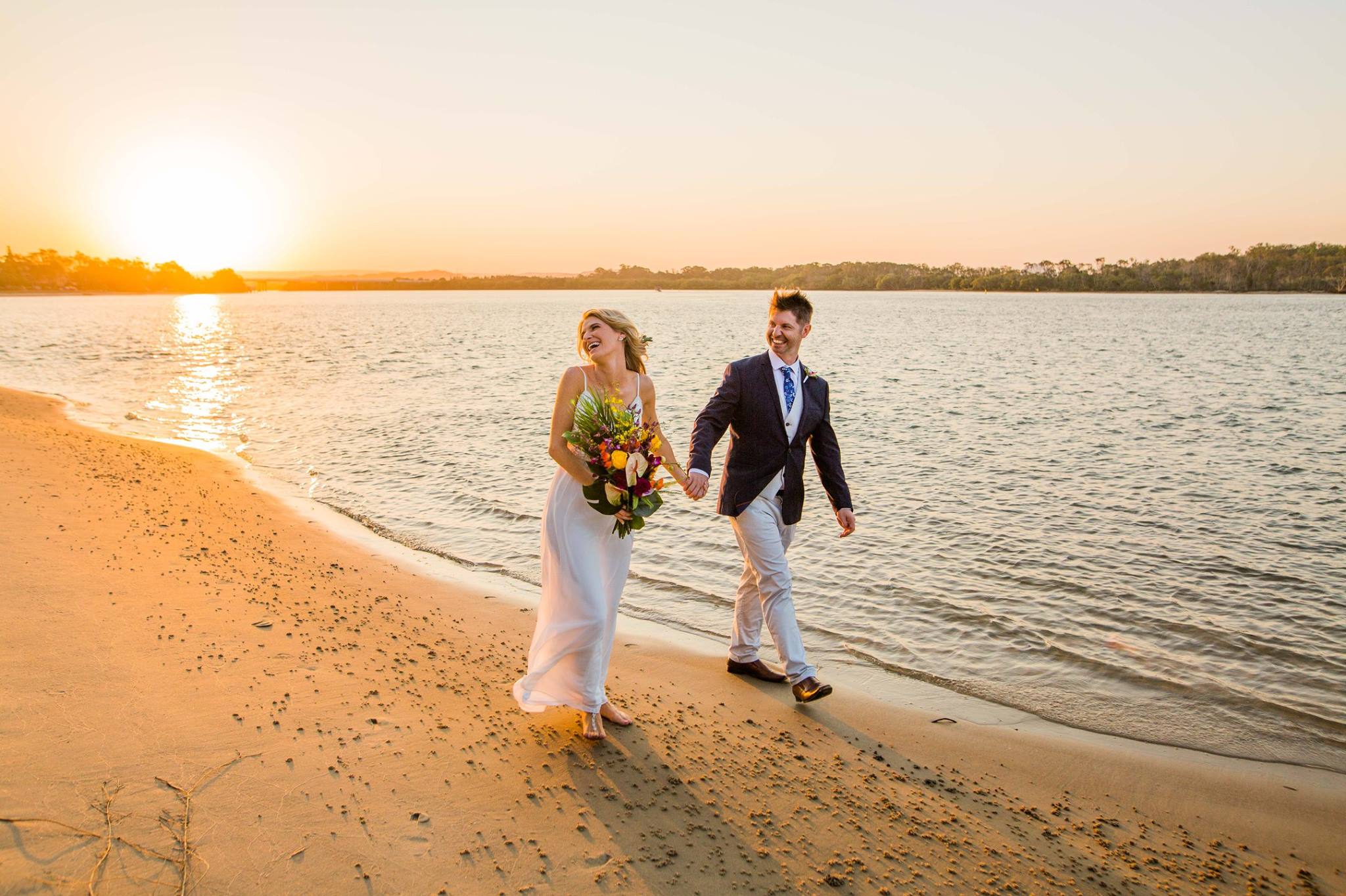 Couple walking on beach at sunset, wedding photography Mackay