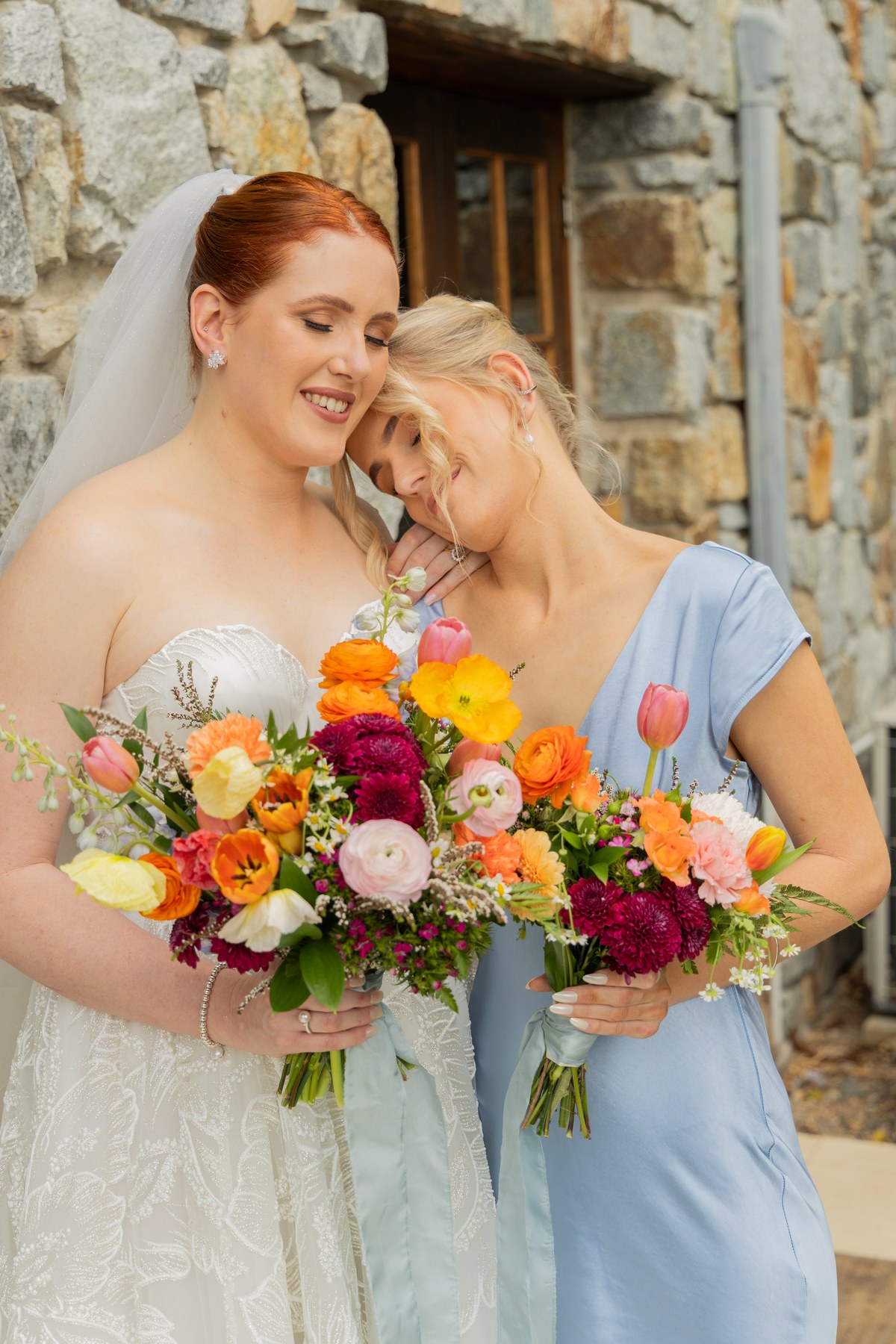 Bride and bridesmaid with flowers Mackay wedding